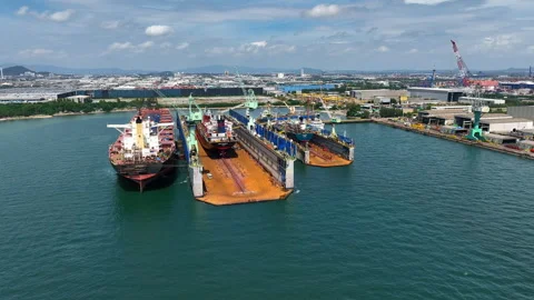 A large cargo ship carrying containers and goods is being maintained at the port Stock Footage 321633566