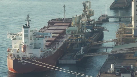 Large cargo ship docking at industrial port terminal. Видео 331118276