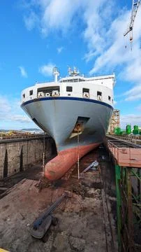 Large Cargo Ship in Dry Dock for Maintenance and Inspection Stock Photos