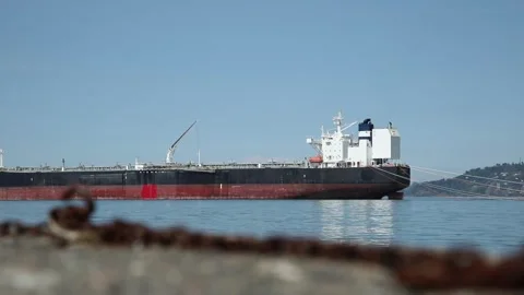 Large cargo ship with gentle water waves movement in calm harbor bay Stock Footage 314501336