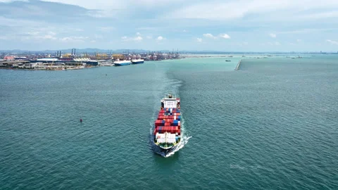 A large cargo ship loaded with containers and goods is sailing out of the port. Stock Footage 321633552