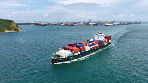 A large cargo ship loaded with containers and goods is sailing out of the port. Stock Footage 321633558