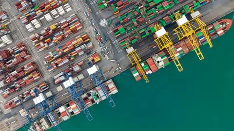 Large Cargo Ship Loading Colorful Containers At Busy Commercial Port High A.. Stock Photos