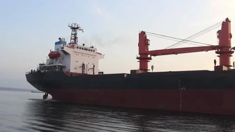 A large cargo ship is moored to the pier in the port to await loading in bulk ca Stock Footage 137256081
