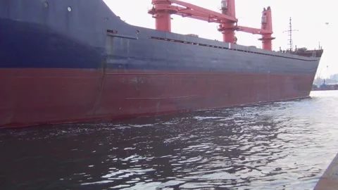 A large cargo ship is moored to the pier in the port to await loading in bulk ca Stock Footage 137256209