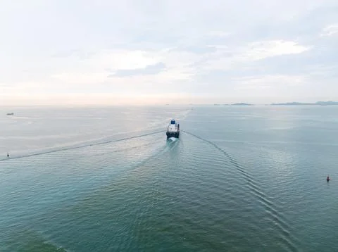 Large Cargo Ship Navigating Calm Coastal Waters Under Overcast Sky High Ang.. Photos