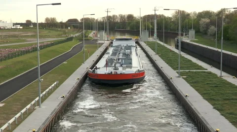 Large cargo ship is navigating in a sluice Видео 49174020