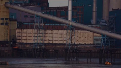 A large cargo ship offloads raw material to the Tate Lyle sugar factory in Stock Footage 70968376