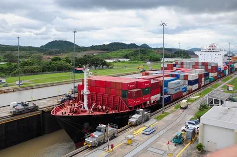 A large cargo ship passes through the Panama Canal, showcasing internationa.. Stock Photos
