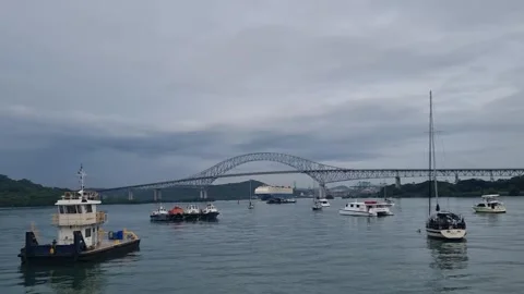 A large cargo ship passes under the Bridge of the Americas in Panama. Stock Footage 343882717