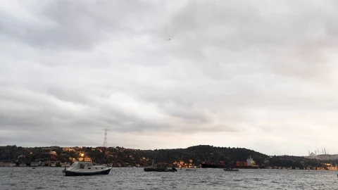 Large Cargo Ship Passing Through the Bosphorus and Small Boats on the Strait Stock Footage 121629217