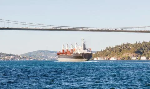 Large cargo ship proceeding along the Bosphorus Channel on the background of  Foto stock