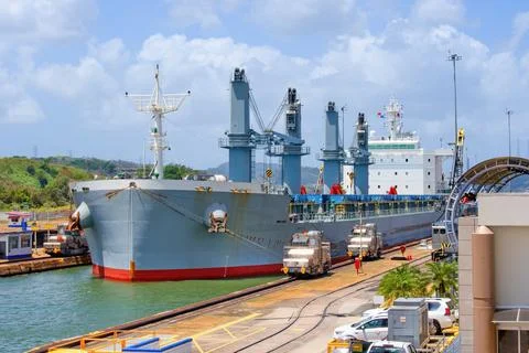 Large cargo ship pulled by special electric  locomotives in Panama Canal  - M Фото