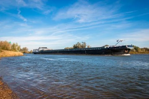 Large cargo ship in the rain river "the IJssel" the Netherlands nearby Deventer Stock Photos