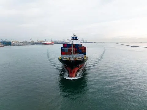 Large Cargo Ship Sailing Through Harbor Waters Wide Angle Shot Stock Photos