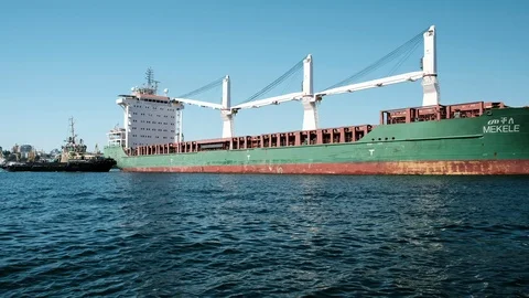 Large cargo ship sails near, the ship is green. Stock Footage 102483964