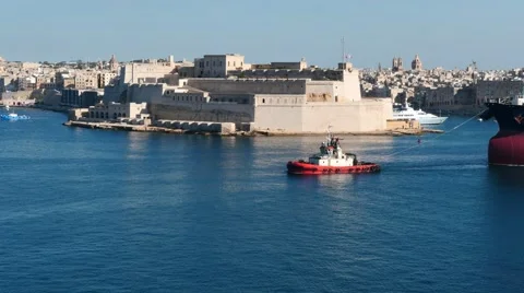Large cargo ship transferring in Valletta port with beautiful fort view Stock Footage 63899253