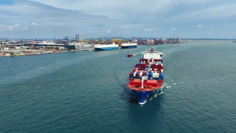 Large cargo ships full of containers sailing in an industrial zone Stock Footage 285144109