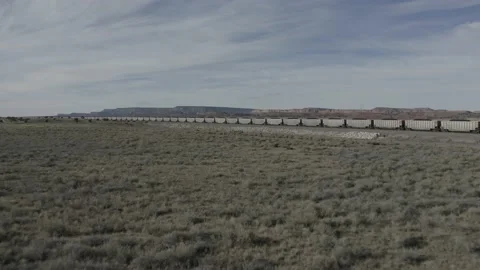 Large cargo train is moving in open western plain Stock Footage 161446282
