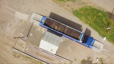 Large cargo trucks weighing cargo on truck scales in rural area Stock Footage 148324717