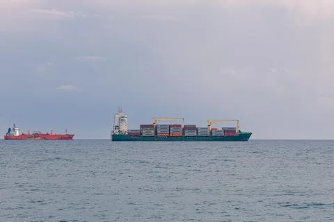 Large cargo vessel loaded with multi-colored containers Stock Photos
