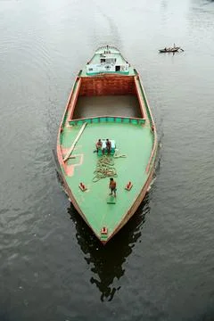 Large Cargo Vessel Navigating River with Workers on Deck Stock Photos