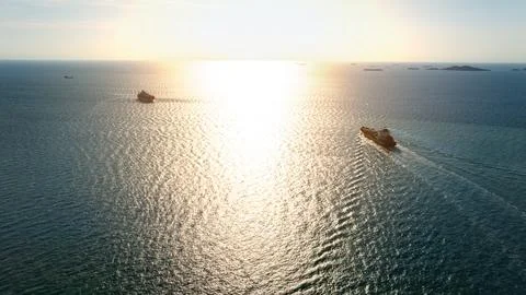 Large Cargo Vessels Transit Open Sea During Radiant Golden Sunset High Angl.. Stock Photos