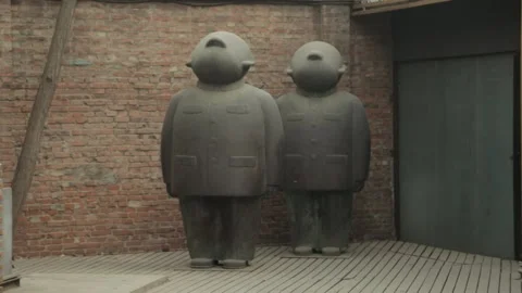 Large Cartoonish Statues Against Brick Wall in 798 Art District, Beijing, China Stock Footage 341780130