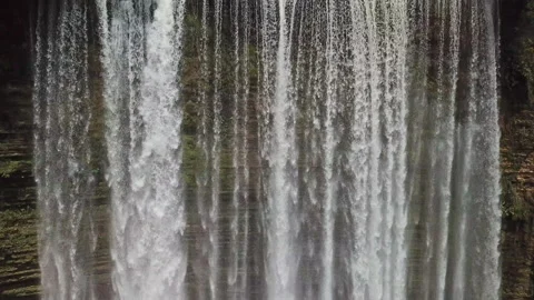 A large cascade of waterfalls falls down in the wild forest of Negros Island 库存影片 120043333