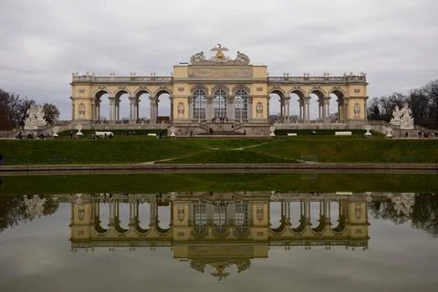 A large castle is reflected in the lake in front of him Stock Photos