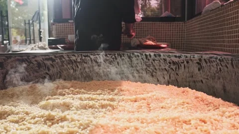 Large cauldron for pilaf with steaming rice Stock Footage 254569856