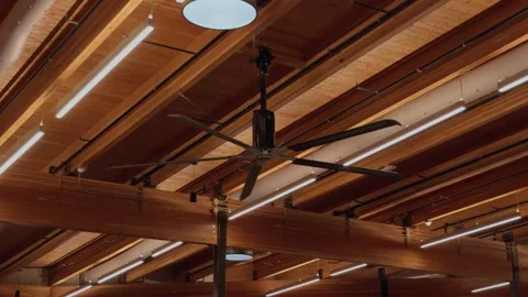 Large Ceiling Fan Rotating Beneath Modern Timber Architecture Interior Stock Footage 337660909