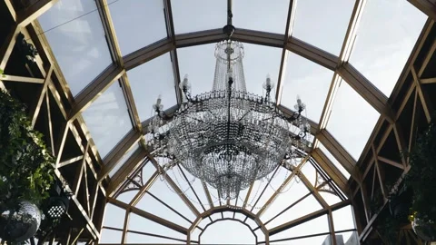 A large chandelier hangs under the glass ceiling Stock Footage 304991904