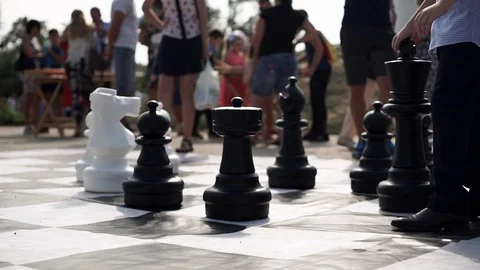 Large chess pieces on a large chessboard at a city event Stock Footage 115312423