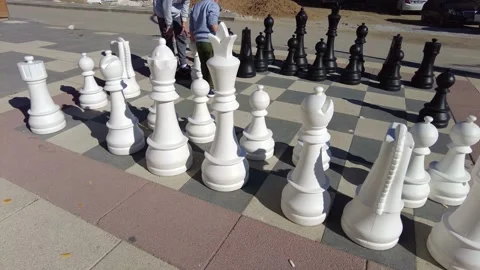 Large chess playground on the pavement, large chess apparatus, children playi Stock Footage 166322787