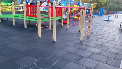 Large Children's Playground with merry-go-rounds and swings in the park Stock Footage 254236580