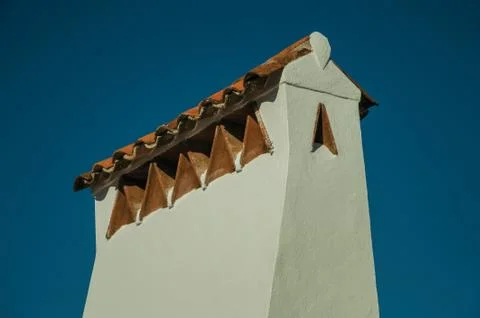 Large chimney covered by rough plaster and rooftop Stock Photos
