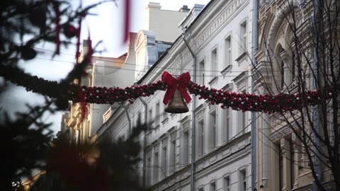 Large Christmas garland hangs between buildings Stock Footage 297119933