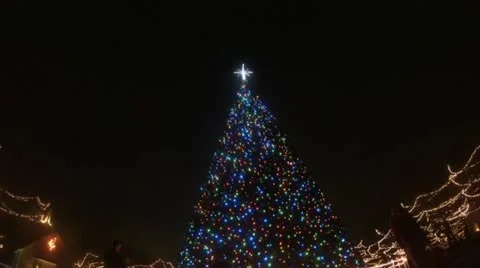 Large Christmas Tree with Blue Lights in Old Village Setting Stock Footage 12690608