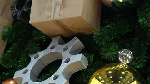 Large Christmas tree decorated with large balls, gears and sealed gifts close-up Stock Footage 145002078