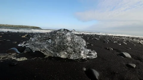 Large Chunk Of Ice Melting On Volcanic Diamond Beach In Iceland Stock-Footage 125205708