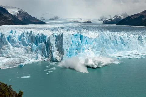 Large chunk of ice from Perito Moreno Glacier is falling into the water Stock Photos