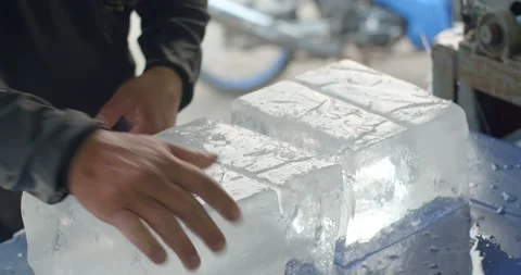 A large chunk of ice was cut with an axe.Close up hand cut ice.A man cut the ice Stock Footage 237503745