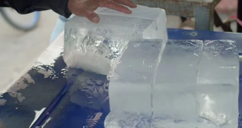 A large chunk of ice was cut with an axe and camera focus into axe.Close up hand Stock Footage 241932139