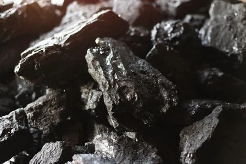 Large chunks of brown coal close-up. Mining and fuel production. Stock Photos
