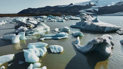 Large chunks of ice float in glacier lagoon. Landscape in Iceland. Clear blue 스톡 동영상 244388682