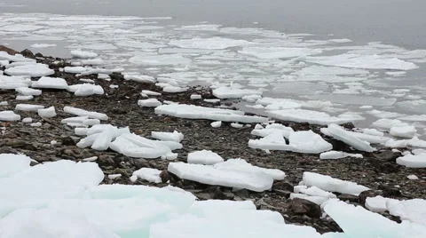 Large chunks of ice sit on a rocky beach near the harbor, Portland Maine Stock Footage 47088562