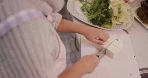 Large chunks of tofu being sliced in Chinese or Japanese kitchen Stock Footage 123789843
