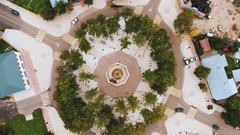 Large circular asphalt road junction with green trees aerial 스톡 동영상 153089896