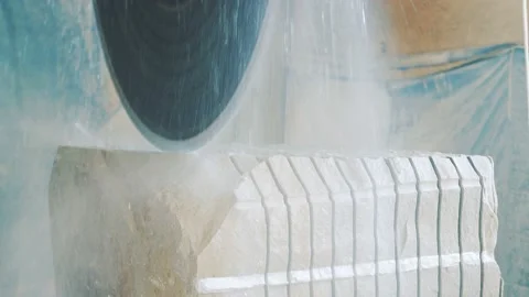 A large circular saw with water cuts the sandstone into individual slabs. Stock Footage 168776795